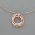 Small playful rings pendant made of rosé gold plated silver